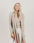 A woman wearing a Kapeka town scarf merino silk blushpink