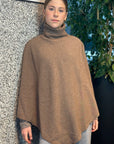 Woman wearing a brown poncho wrap