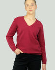 Woman wearing a red v neck sweater