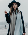 Woman wearing a Merinosilk Lodge Wrap and hat outside- Kapeka NZ