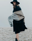 Woman wearing a Merinosilk Lodge Wrap and hat