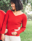 Woman wearing a Pink Red Merino Possum V neck sweater