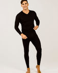 A man wearing a black long-sleeved merino wool V-neck sweater.