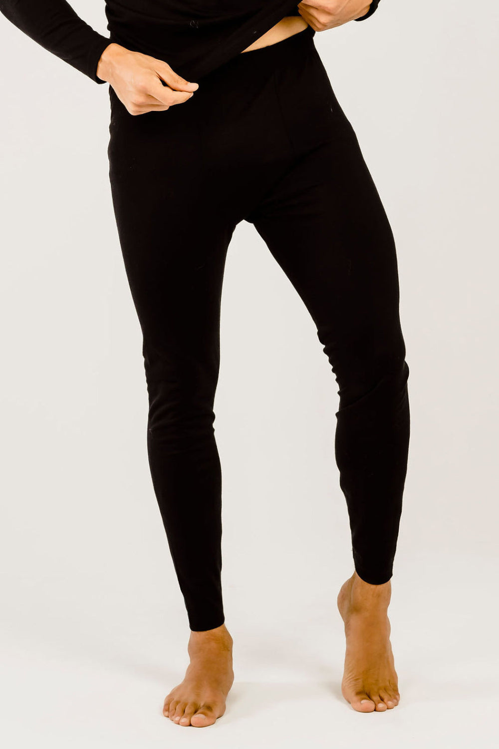 Person wearing black leggings on a white background