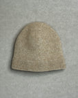Beige knit baby beanie on a gray background