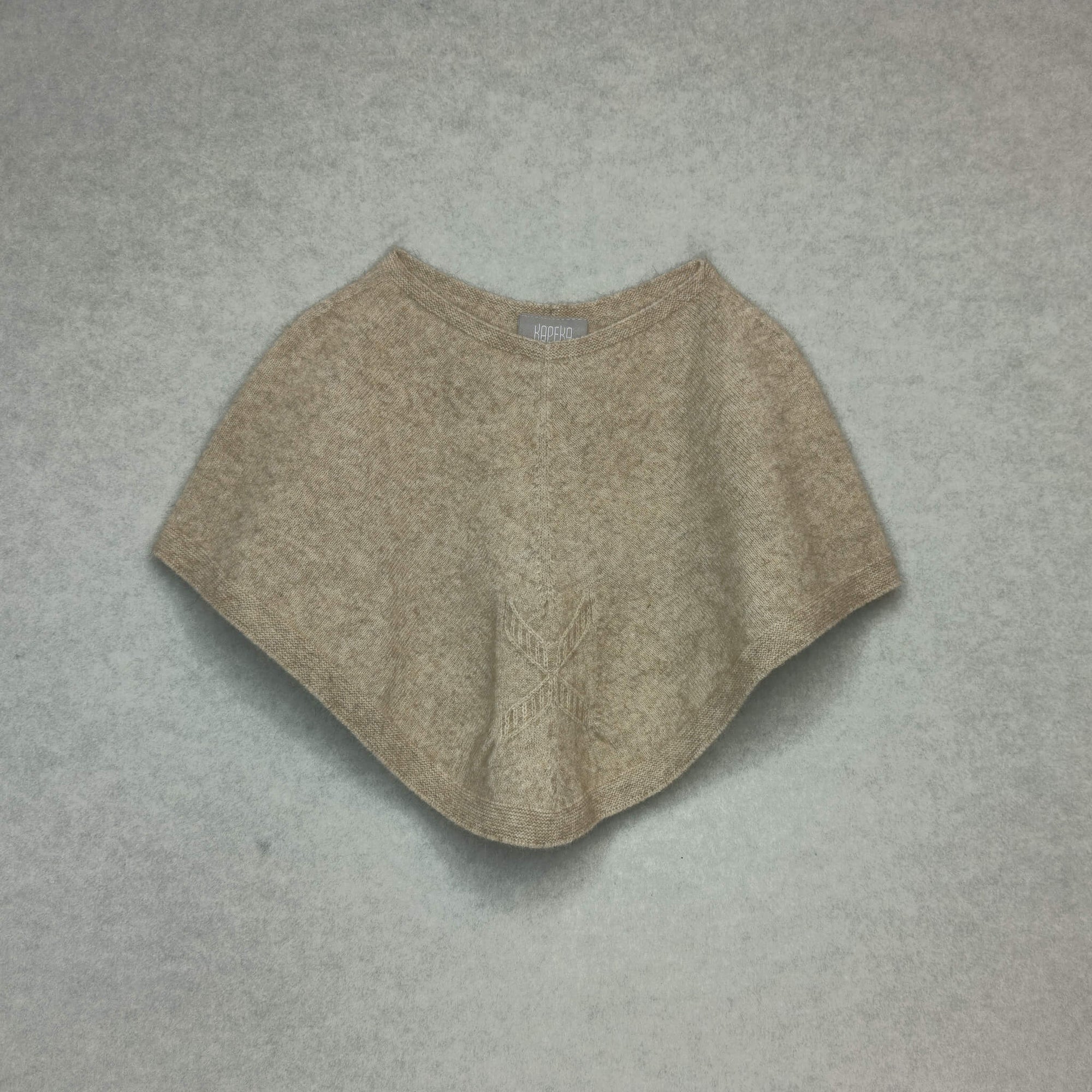 Beige poncho on a gray background