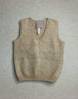Brown knitted baby vest with a label on a gray background