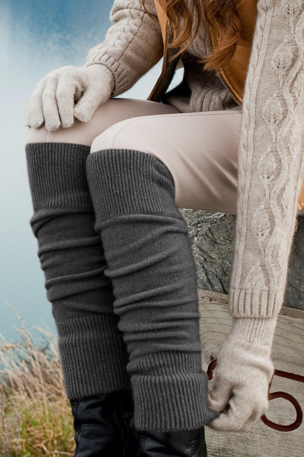 Woman wearing grey legwarmer outside.