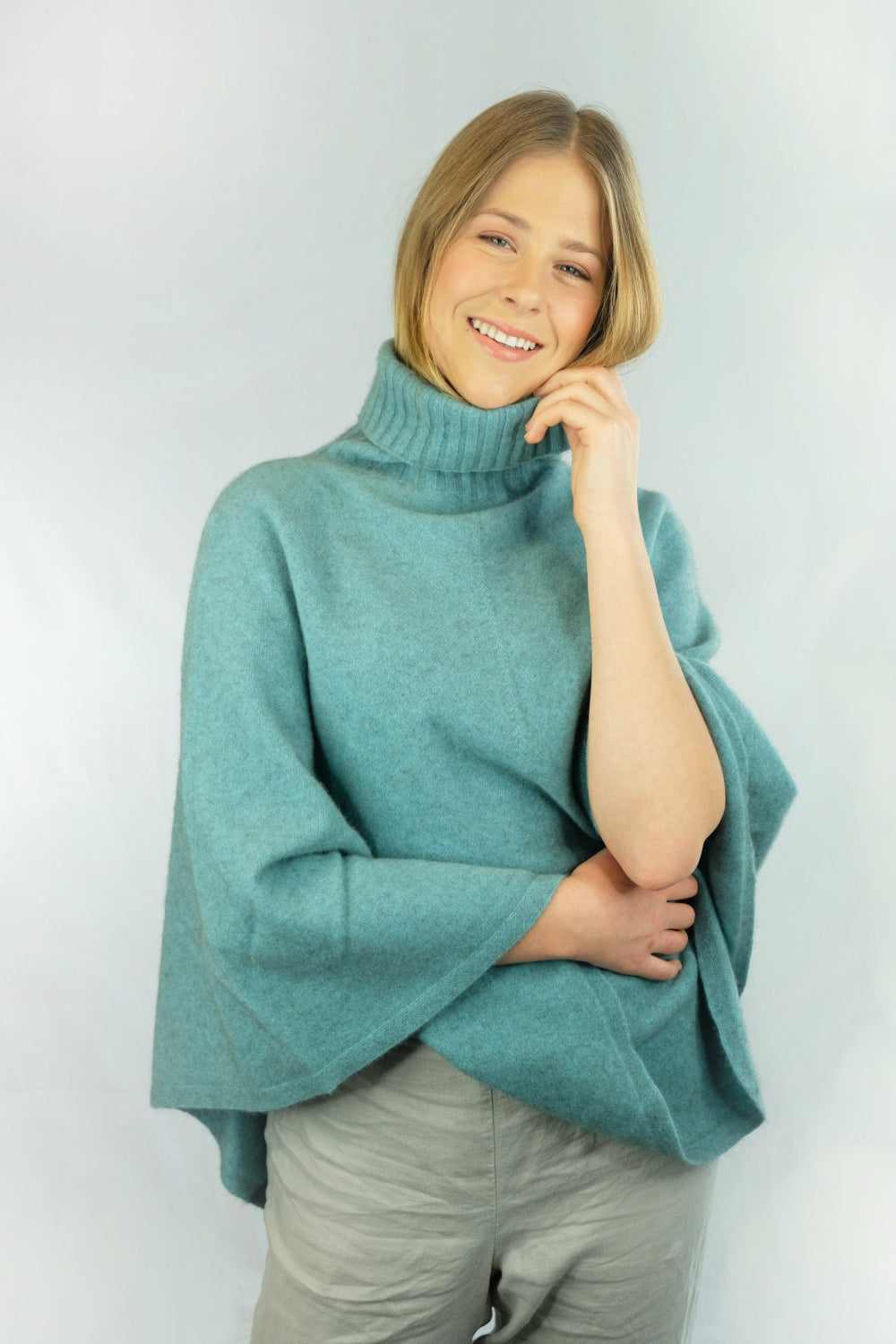 Woman wearing a sea green wrap poncho