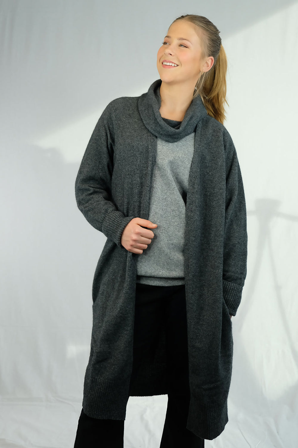 Woman wearing long charcoal cardigan