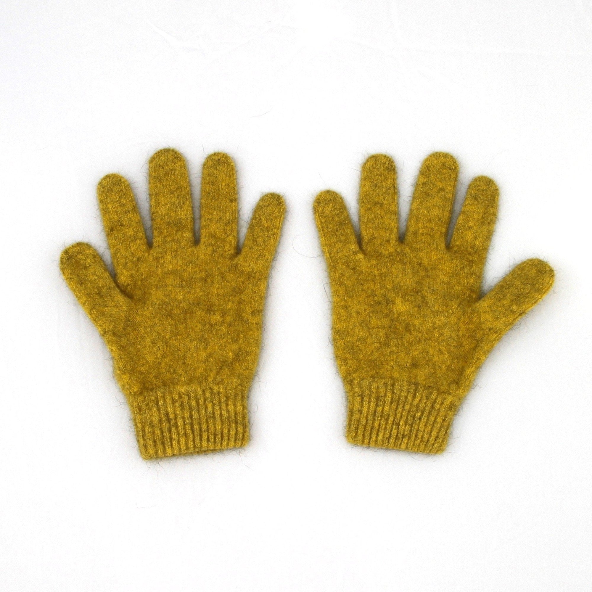 Pair of mustard yellow gloves on a white background