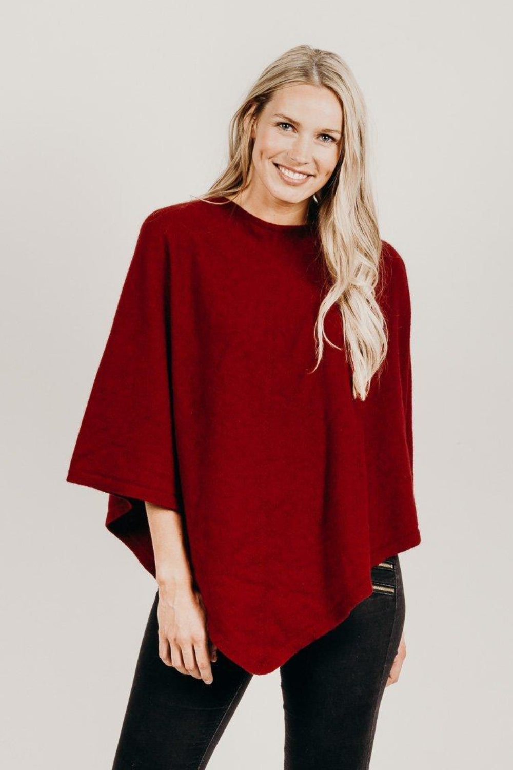 Woman wearing a fire poncho with black pants