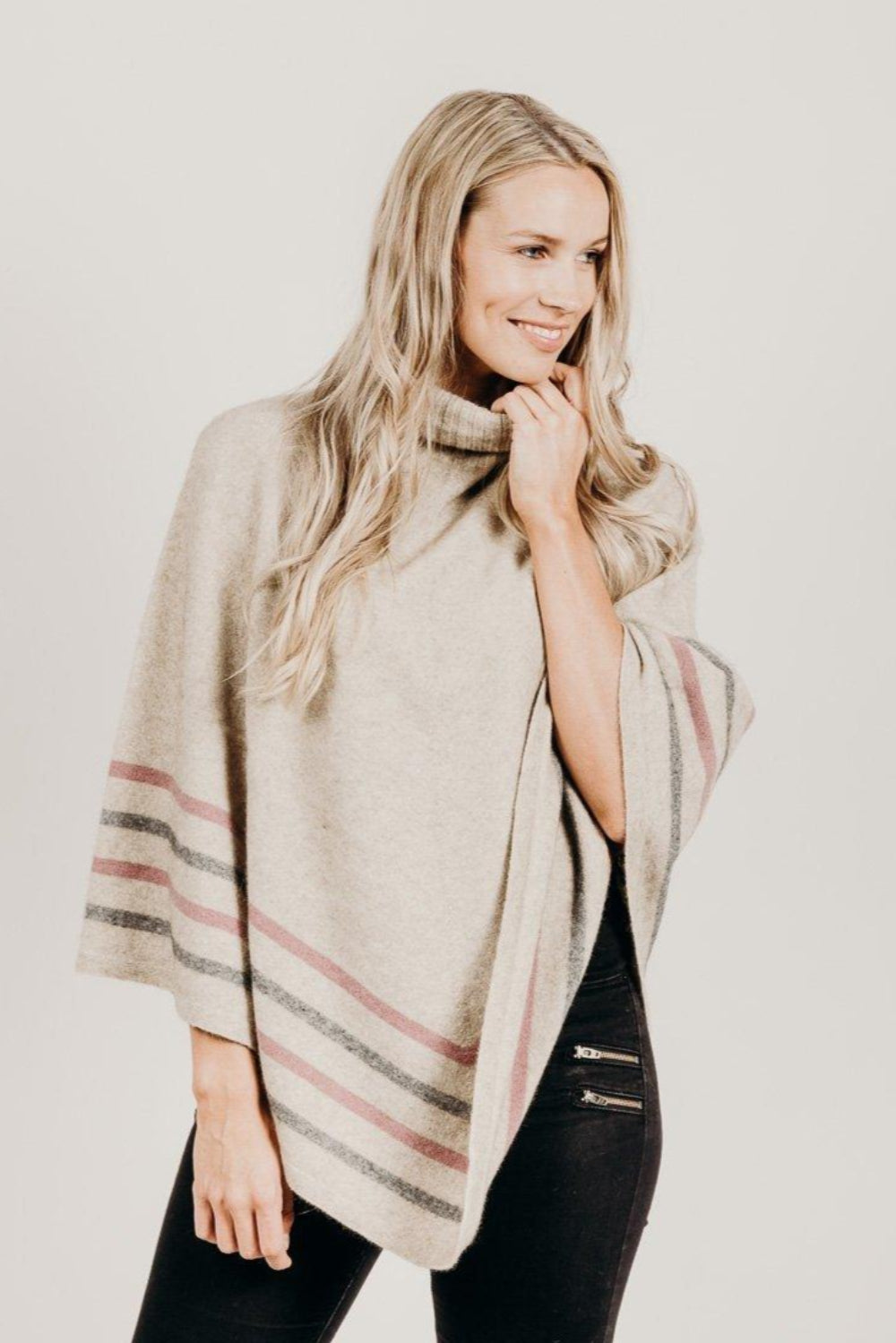 Woman wearing a　Lichen Merinosilk Stripe Poncho with black pants
