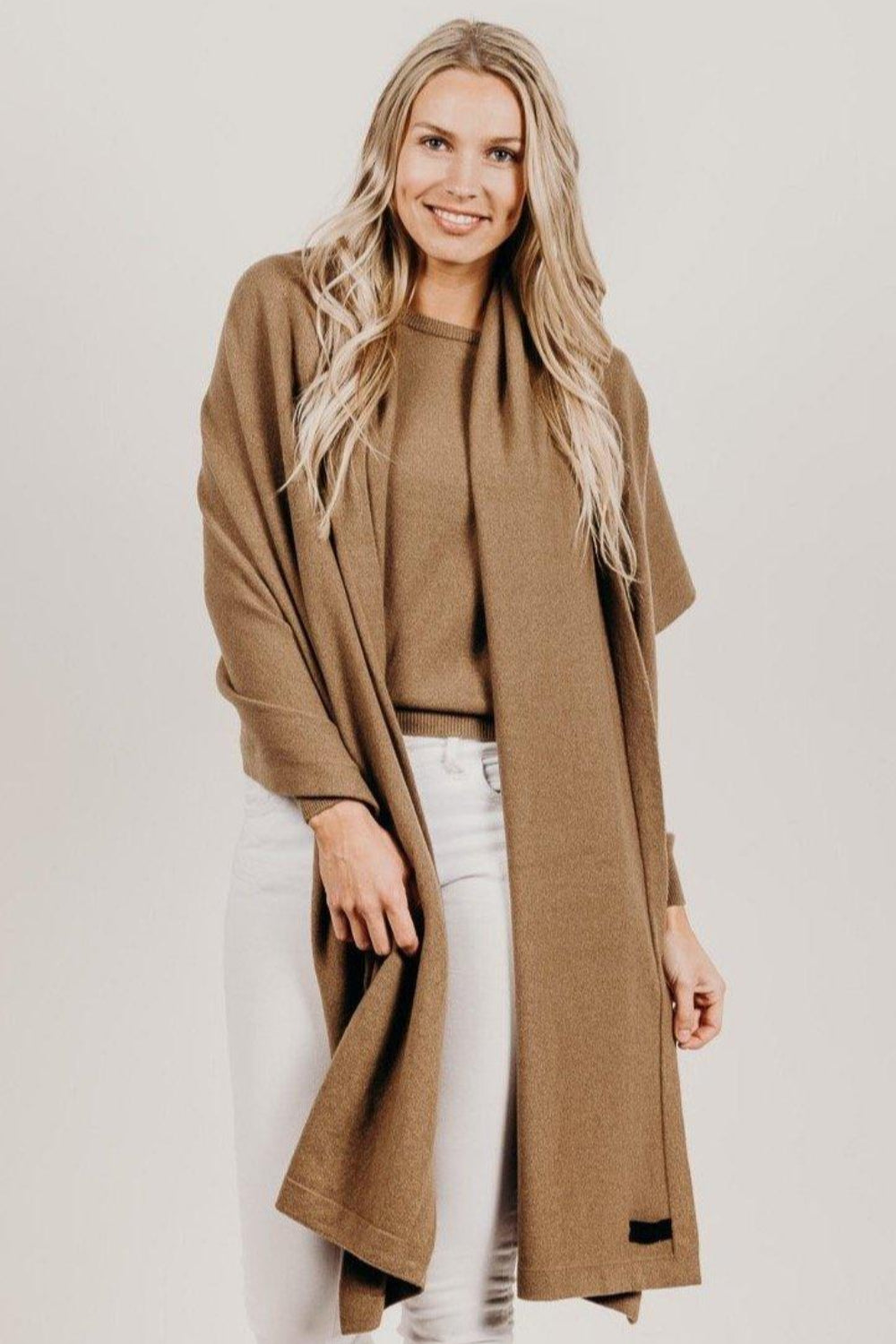 Woman wearing a light brown Classic Cervelt Scarf - Kapeka NZ, Made from New Zealand Red Deer Fibre. Very Soft and rare Fibre. Only made in New ZealandClassic Cervelt Wrap - Kapeka NZ