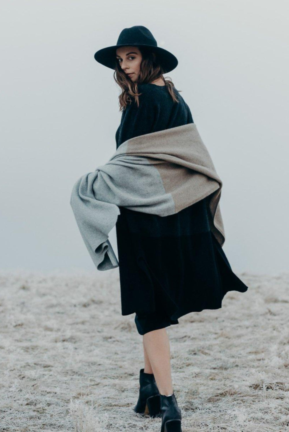 Woman wearing a Merinosilk Lodge Wrap and hat