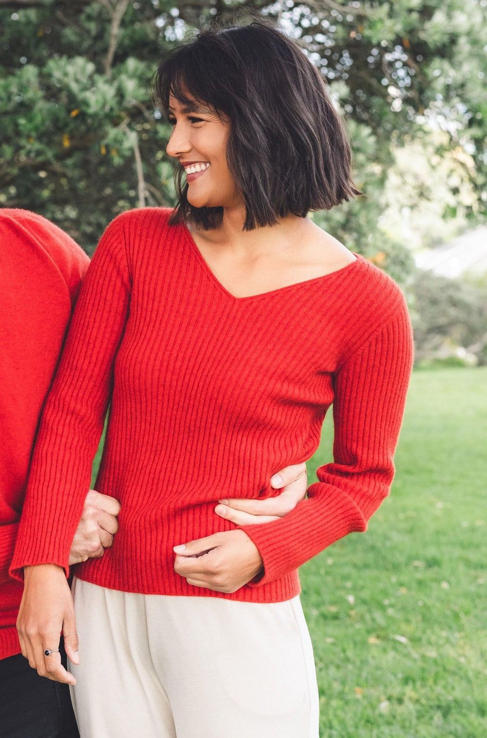 Woman wearing a Pink Red Merino Possum V neck sweater