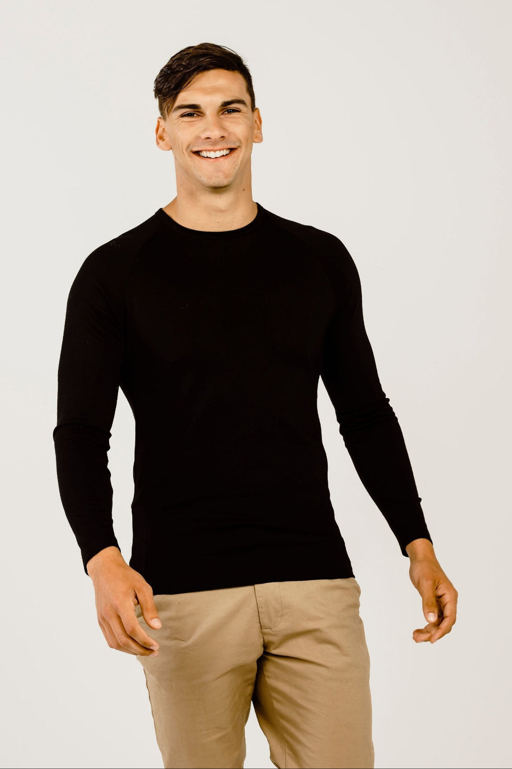 Man wearing a long sleeve shirt with beife pants