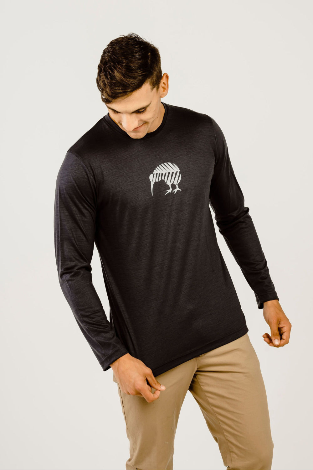 Man wearing a black long-sleeve shirt with a logo on a white background